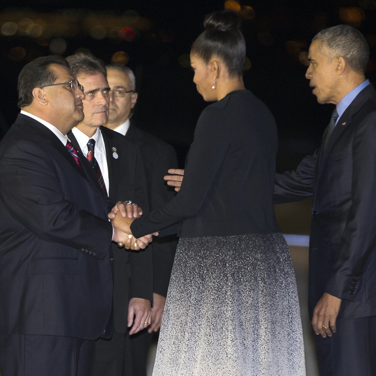 First Lady Michelle Obama and President Barack Obama shake hands with city and county officials