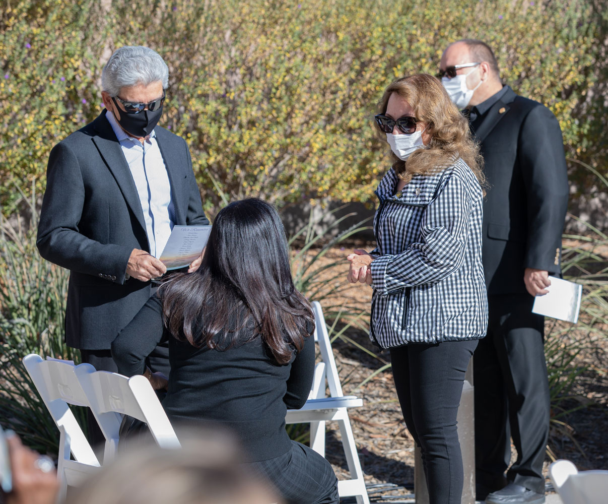 Supervisor Josie Gonzales speaks to a visitor during the Curtain of Courage Memorial Unveiling