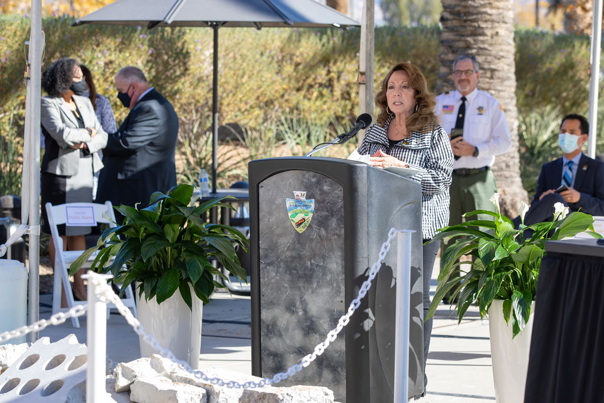 Supervisor Josie Gonzales speaks at a podium during the Curtain of Courage Memorial Unveiling