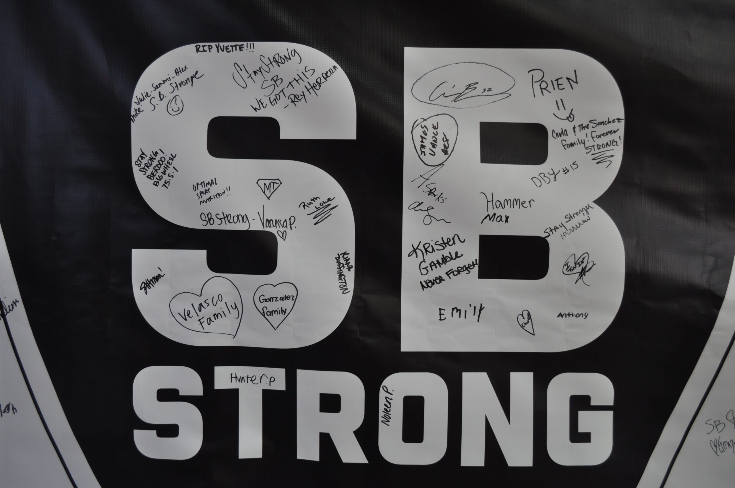A sign that says SB Strong signed by members of the community