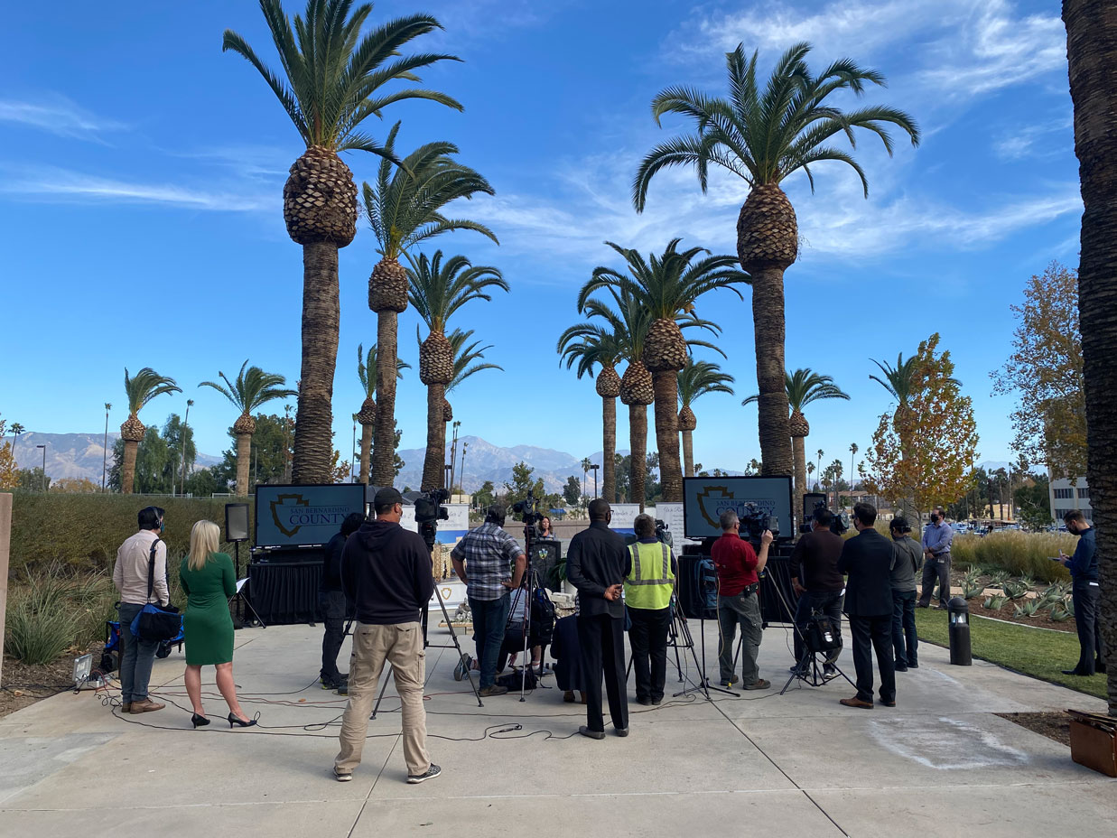 The news media gathers with television cameras outside the San Bernardino County Government Center
