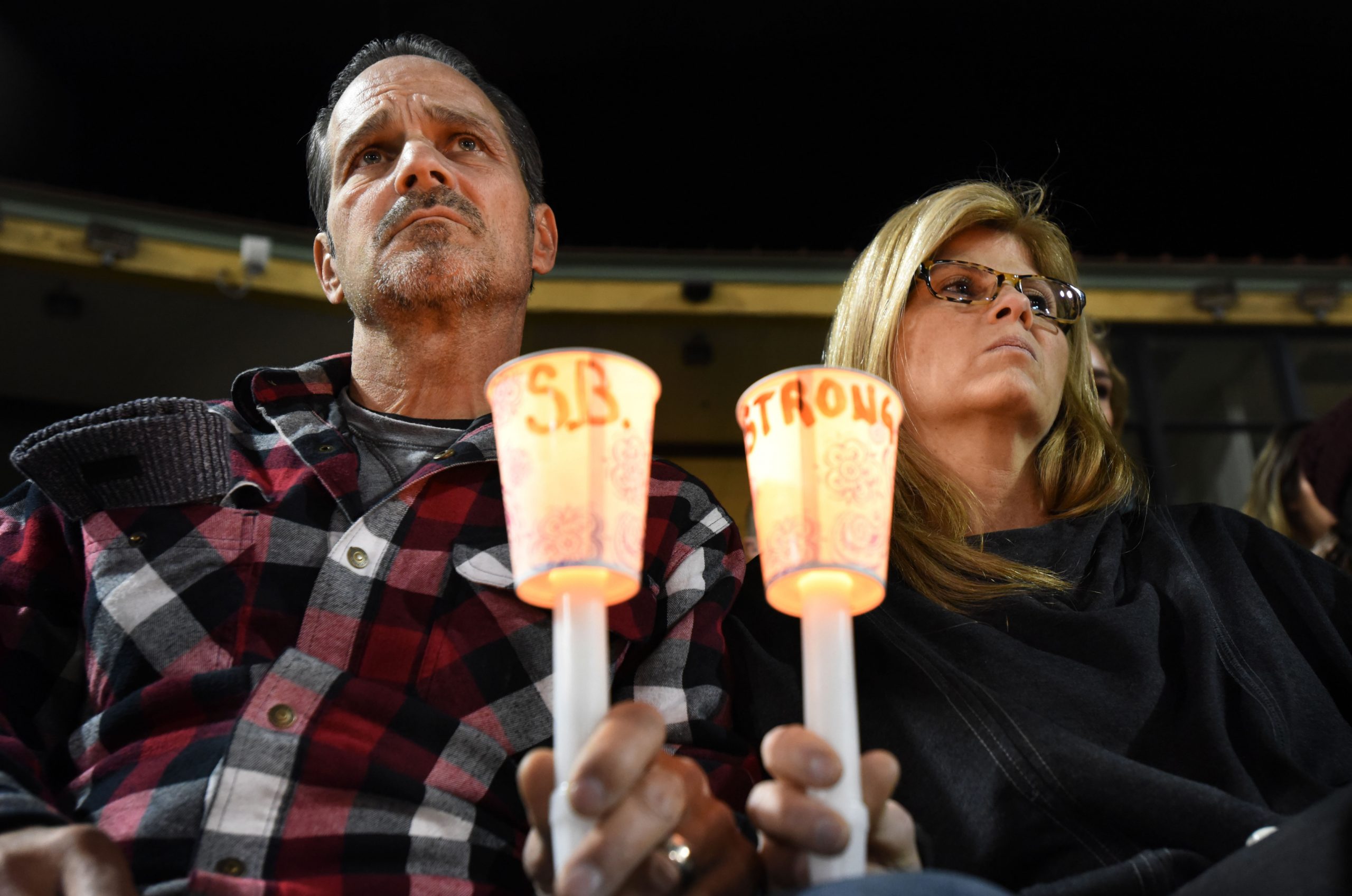 Gordon and Denise Baciorek of Temecula show their support during a candle light vigil for the victims of yesterdays mass shooting at the Inland Regional Center is head at San Bernardino's San Manuel Stadium in San Bernardino Thursday, Dec. 3, 2015. - The Press-Enterprise