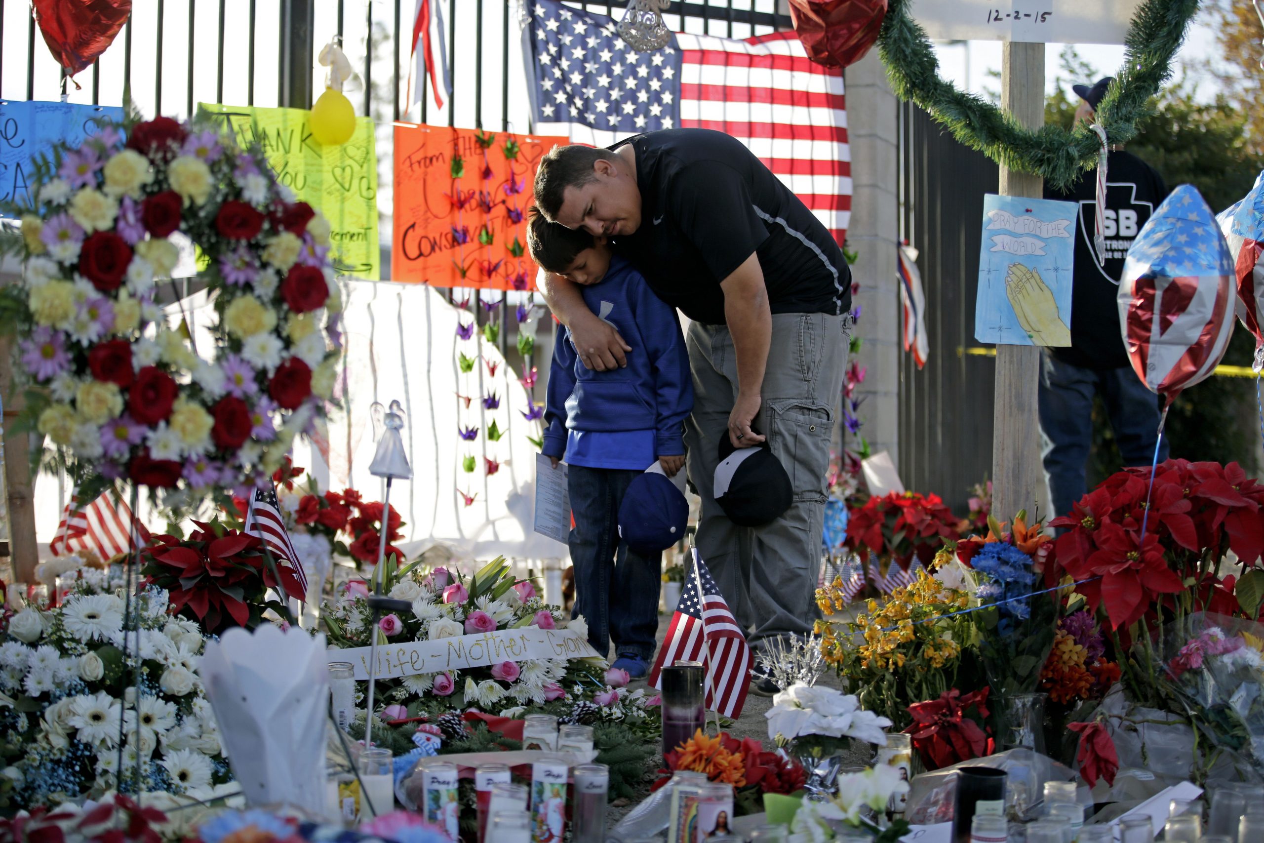 A man and child gather at the site of a Memorial to the victims