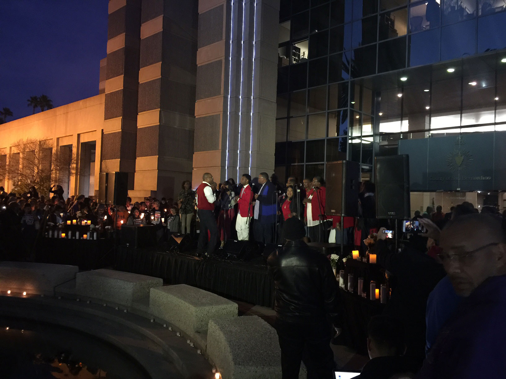 A group of people hold a vigil outside the County Government Center